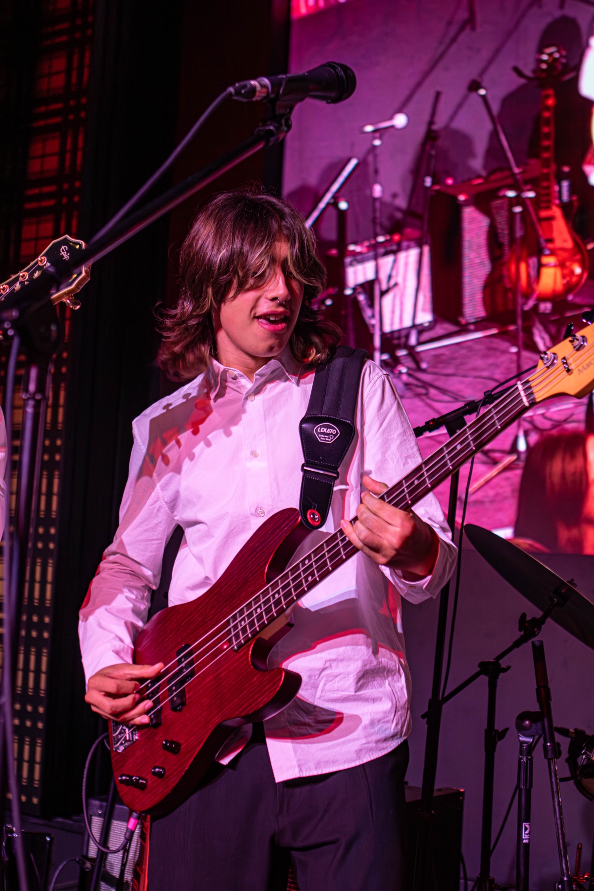 BTN bassist playing a red electric bass.
