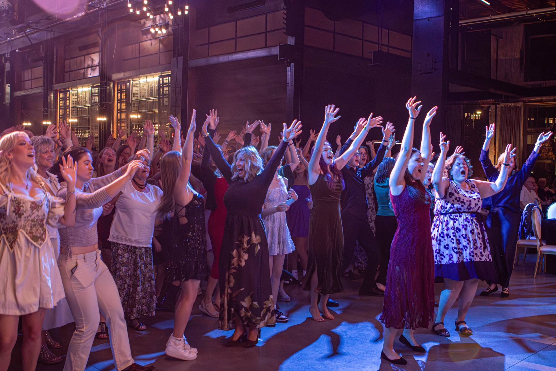 The Big Night Out audience cheering with their hands raised.