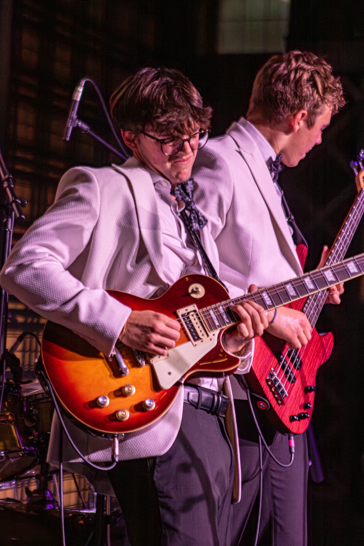 BTN guitarist playing a sunburst electric guitar beside the bassist.