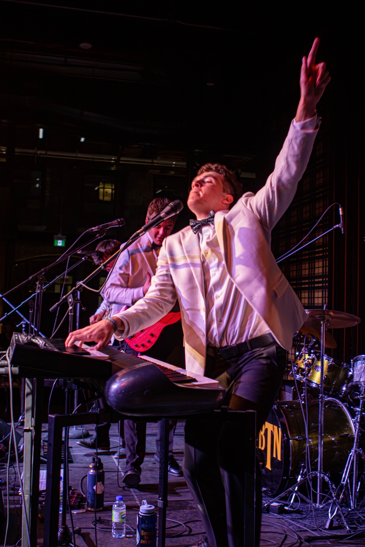 BTN keyboardist playing with one hand raised.